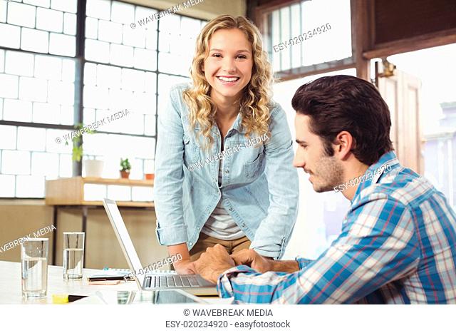 Portrait of woman helping colleague