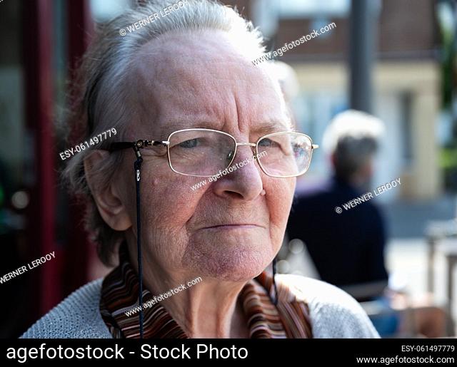 Portrait of a 84 yo grandmother looking with a serious expression, Tienen, Belgium