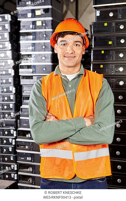 Worker in computer recycling plant, portrait