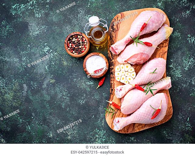Raw chicken legs with spices and garlic. Top view