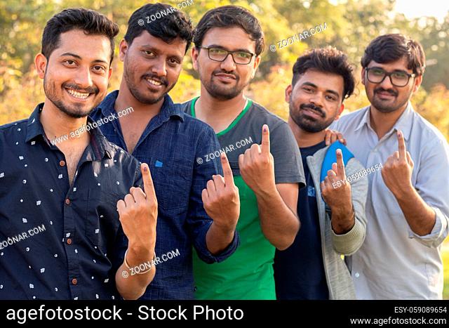 Group of Young Indian Voters showing fingers after casting there votes