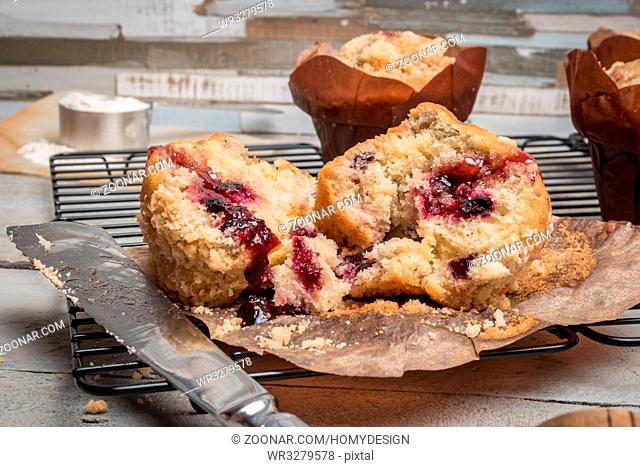 Muffins with red fruits jam fill on wooden counter top