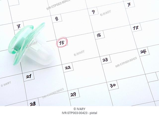 Pacifier on calendar showing 15th day of the month