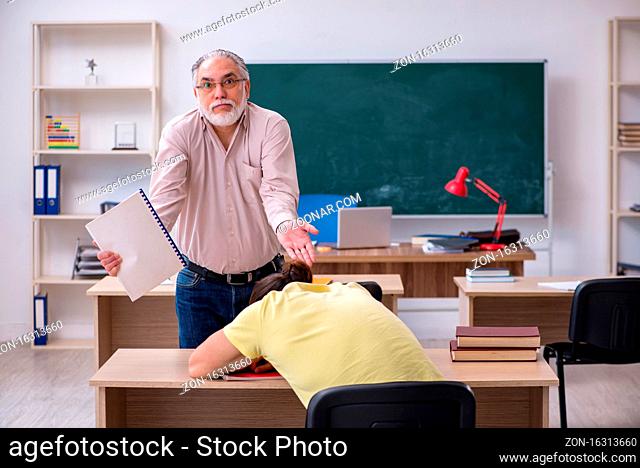 Old teacher and young student in the classroom