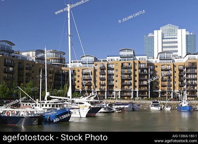 Luxury waterfront apartments and boats at St Katherine's Dock, London, E1, England, UK