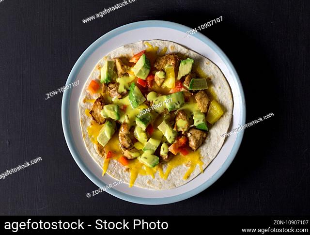 Open wrap with chicken, avocado and peppers - Overhead photo