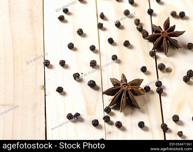 Spices and herbs. Food and cuisine ingredients. anise stars and black peppercorns on a wooden background