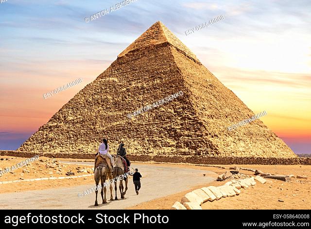 Tourists on camels with bedouin near the Pyramid of Chephren, Egypt