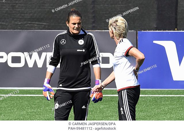 GermanyÕs head coach Silvia Neid (R) and goalkeeper Nadine Angerer speaks during a training session at the Avenue Bois-de-Boulogne, Laval in Montreal, Canada
