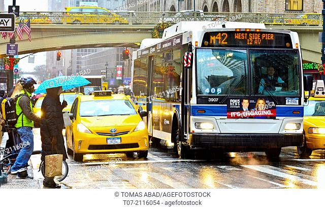 Mass Transit on Pershing Square, M42 MTA Crosstown Bus, outside Grand Central Terminal, morning rush hour during a snow and rain storm, Madison Avenue