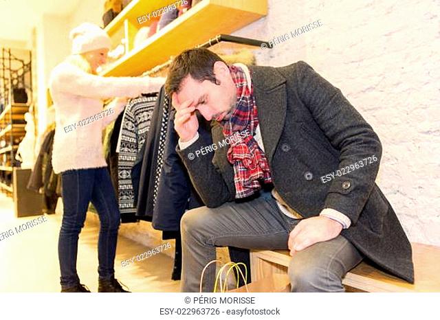 Young casual man waiting while his wife's shopping