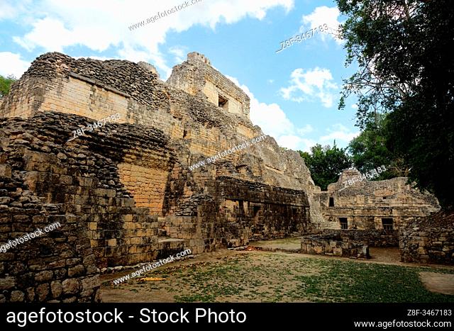The back portion of the Structure X step pyramid in the ancient Mayan city of Becan, Mexico, reveals a variety of levels and rooms beneath a pale blue sky