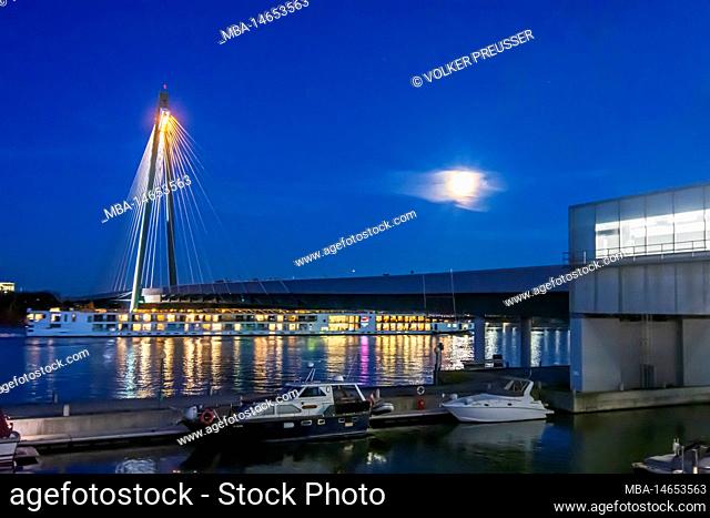 Vienna, full moon above river Donau (Danube), subway U2 bridge Donaustadtbrücke, Marina Wien with boats, cruise ship in 02. Leopoldstadt, Austria