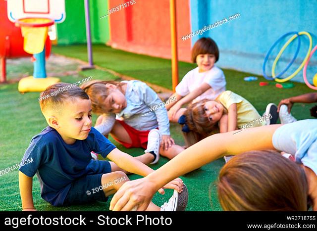Gruppe Kinder macht zusammen Gymnastik in der Kindertagesstätte oder in der Vorschule
