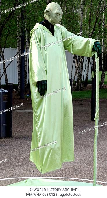 Street performer dressed as Yoda. The performer is creating the illusion that he is floating. London, United Kingdom. Dated 1015