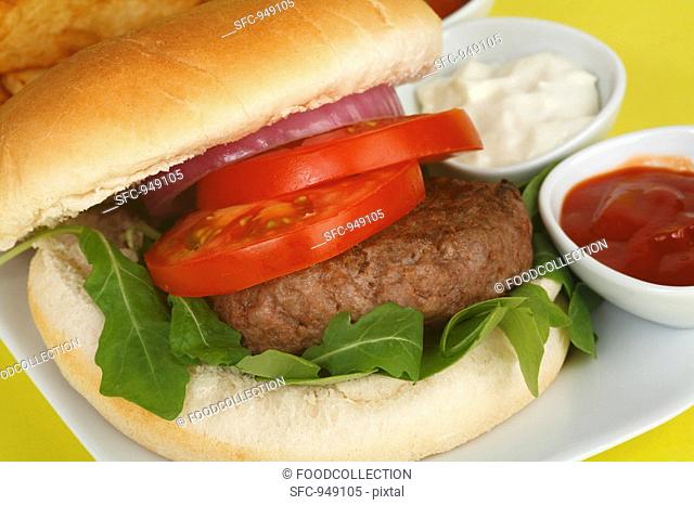 Hamburger with tomato, rocket, mayonnaise and ketchup