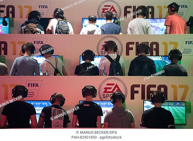 Visitors playing the game FIFA 17 at the EA Sports stall at the Gamescom gaming convention in Cologne, Germany, 18 August 2016