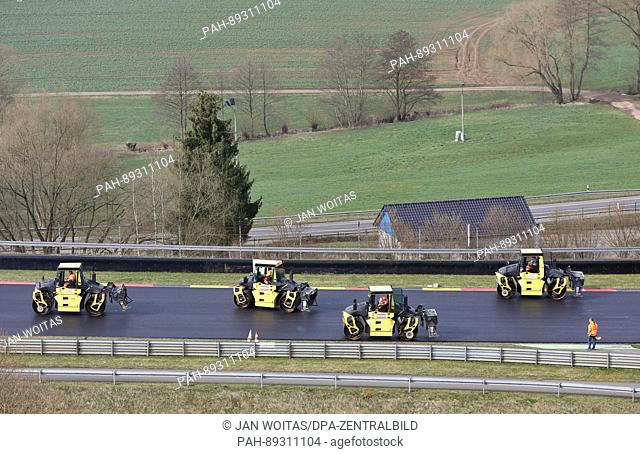 Several rollers compress the new asphalt surface in the entry to the ""Omega"" on the Sachsenring motorracing course in Hohenstein-Ernstthal, Germany