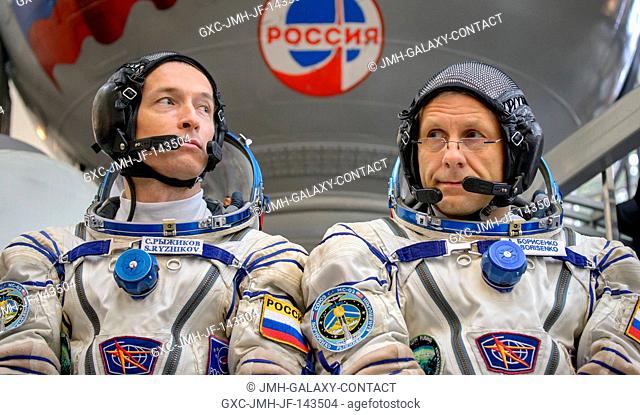 Expedition 49 Russian cosmonauts Sergei Ryzhikov, left, and Andrey Borisenko of Roscosmos answer questions from the press outside the Soyuz simulator ahead of...