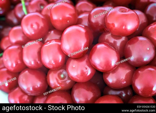 A large number of large ripe cherries with stalks background image