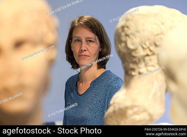 PRODUCTION - 25 July 2023, North Rhine-Westphalia, Cologne: Kathrin Jascke, deputy director at the Roman-Germanic Museum, stands among sculptures
