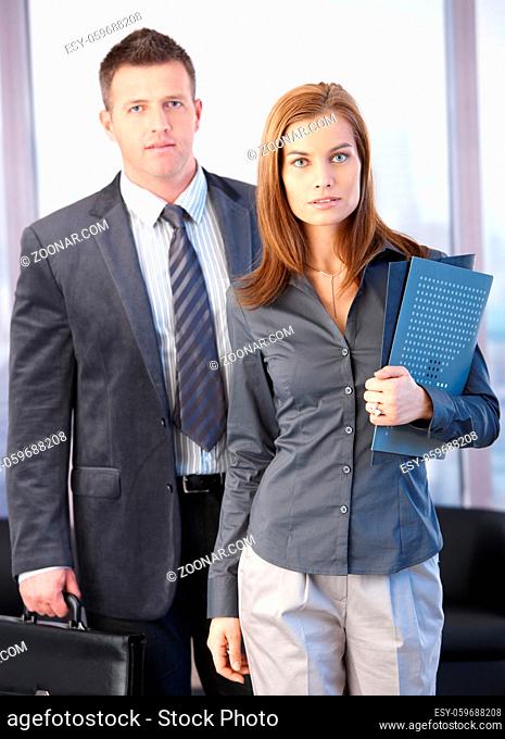 Boss and secretary going to business meeting, holding files and briefcase