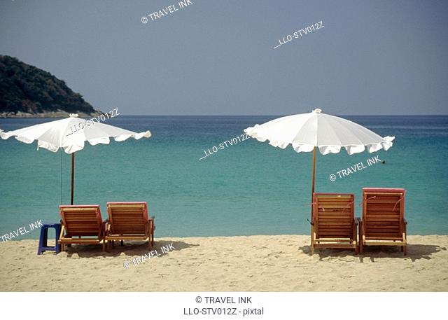 Beach Chairs and Umbrellas Looking Out to Sea  Nai Harn Beach, Phuket Island, Thailand