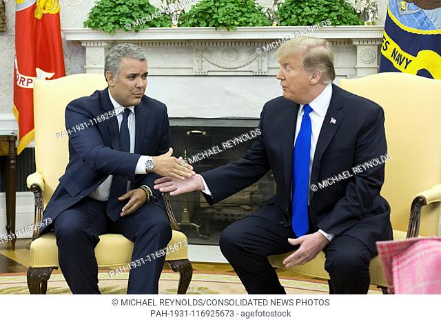 US President Donald J. Trump (R) shakes hands with the President of Colombia Ivan Duque (L) during their meeting in the Oval Office of the White House in...
