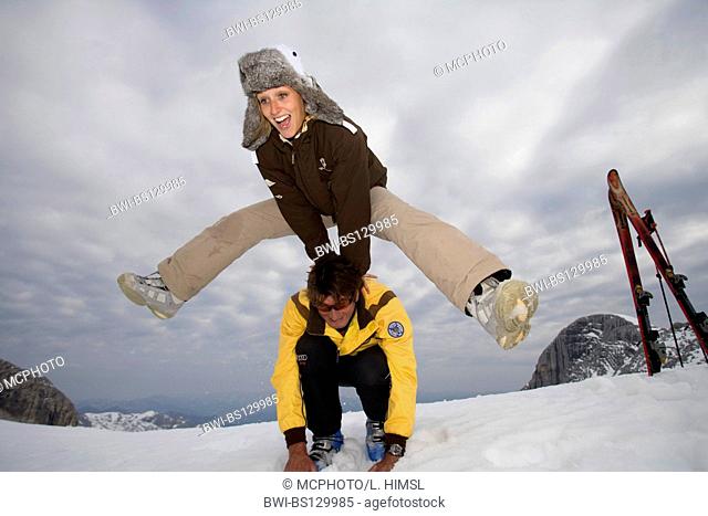 Woman doing a leapfrog over her boyfriend