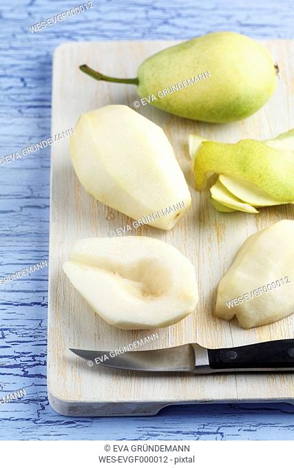 Pears with knife on chopping board, close up