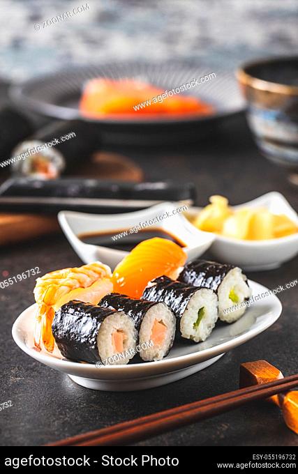 Japanese sushi food. Maki and nigiri roll sushi with salmon, caviar, avocado and tuna