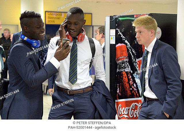 Wolfsburg's players Junior Malanda (L), Josuha Guilavogui and Kevin De Bruyne wait for their suitcases at the airport in Liverpool, Britain, 17 September 2014