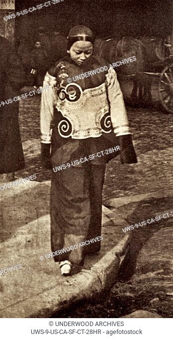 San Francisco, California: c. 1890 A slave girl in Chinatown wearing holiday attire. From a photograph by Arnold Genthe