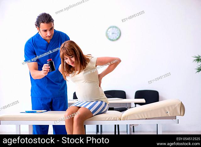 The pregnant woman visiting male doctor gynecologist