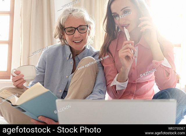 Mother and daughter leading the family business from home being busy