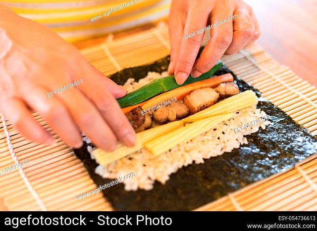 prepare and make homemade sushi on the table at home