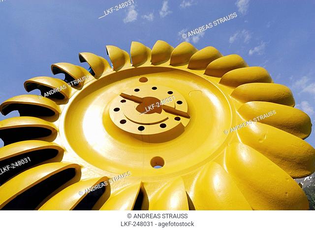 Yellow turbine wheel, Pelton turbine, water power plant near Loebbia, Bergell range, Grisons, Switzerland
