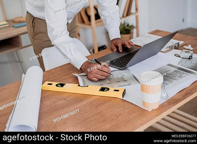 Hands of architect working at desk