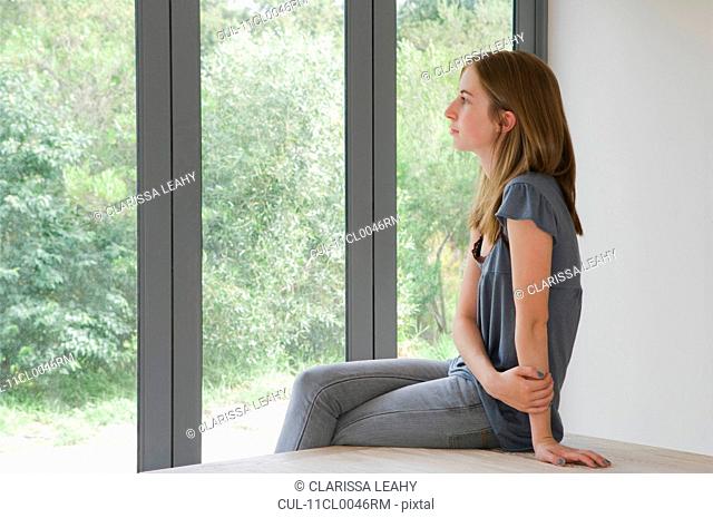 Woman looking out of folding doors