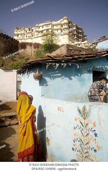 Woman outside her house with her son ; Village Delwara ; Udaipur ; Rajasthan ; India