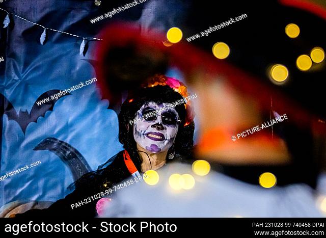 28 October 2023, Berlin: Anne has her picture taken after crossing the finish line at the Halloween Run Berlin 2023. The course leads through the Volkspark...