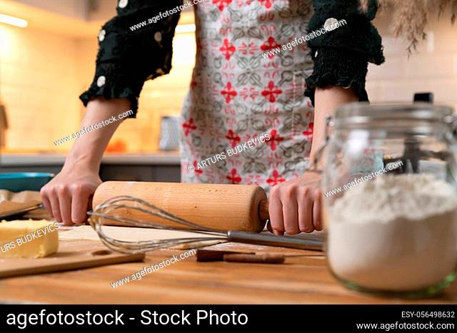 Women preparing homemade food pie, pizza, pasta with a dough roll. Hobbies and family life concept