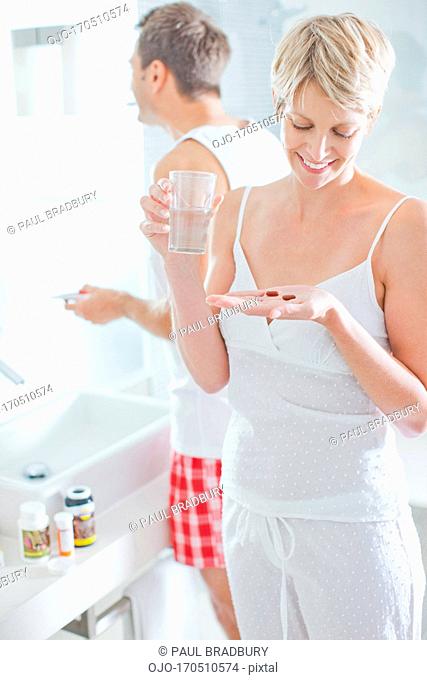Woman taking vitamins in the morning