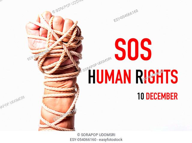 Rope on fist hand with SOS HUMAN RIGHTS DAY 10 december text on white background, Human rights day concept