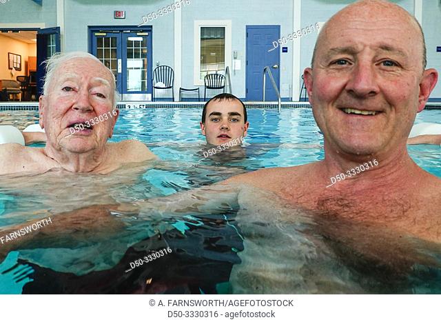 Solomons Island, Maryland, USA A grandfather, son and grandson bathing together in a pool