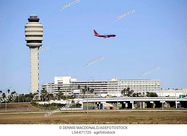 Airplane Jet prepares to land Control Tower at Orlando International Airport Florida