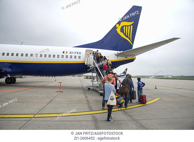 Tourists boarding a Ryanair airplane at Eindhoven airport