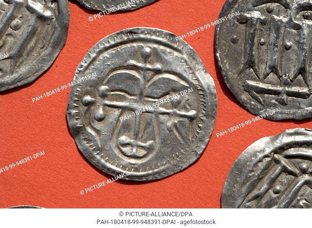 13 April 2018, Germany, Schaprode: A 'Kreuzbrakteate' under Harald Bluetooth (910-987); first own coin type of Denmark, is on a table