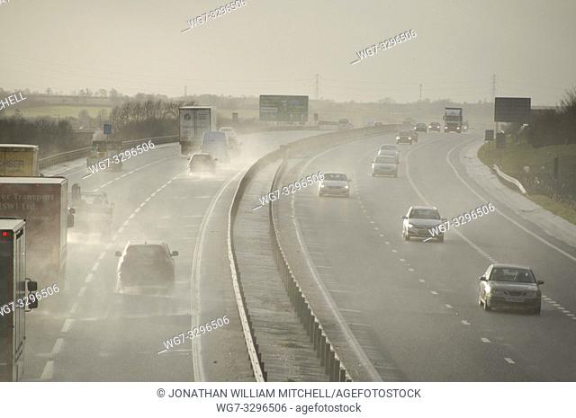 UK Bedfordshire -- 12 Feb 2014 -- Hazardous conditions on the busy A421 near Bedford England UK this afternoon as high winds from a large Atlantic storm caused...
