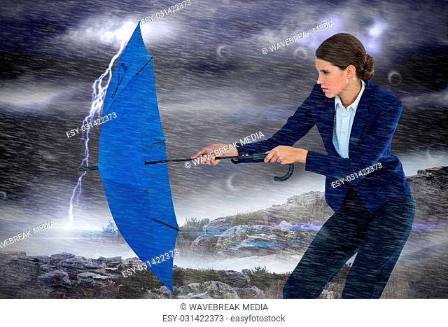 Composite image of businesswoman holding blue umbrella